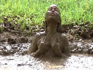 oriental lass having fun in mud 